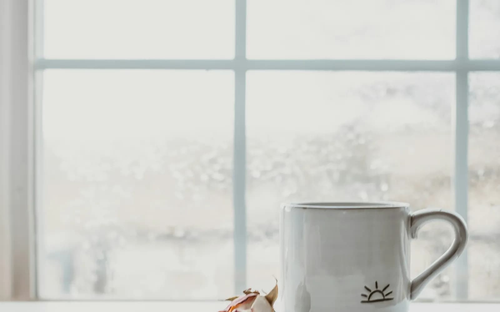 white ceramic mug on white table