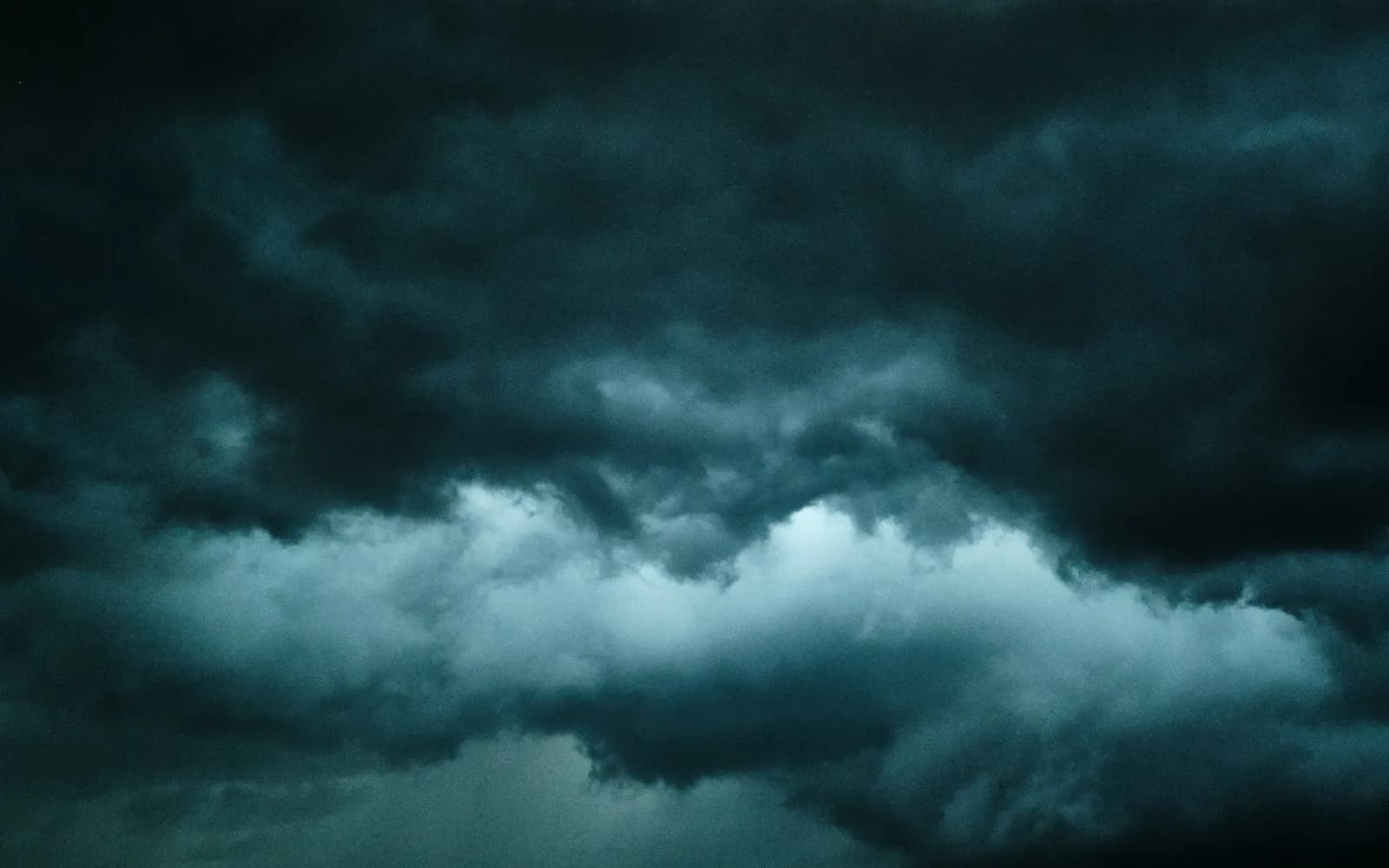 a plane flying through a dark cloudy sky